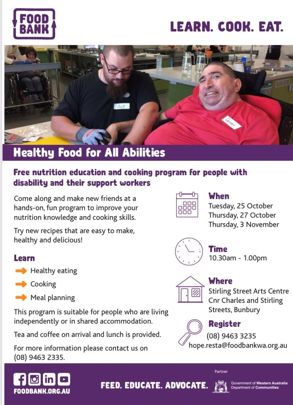 Photograph of man in wheelchair being assisted by another man to prepare a meal.